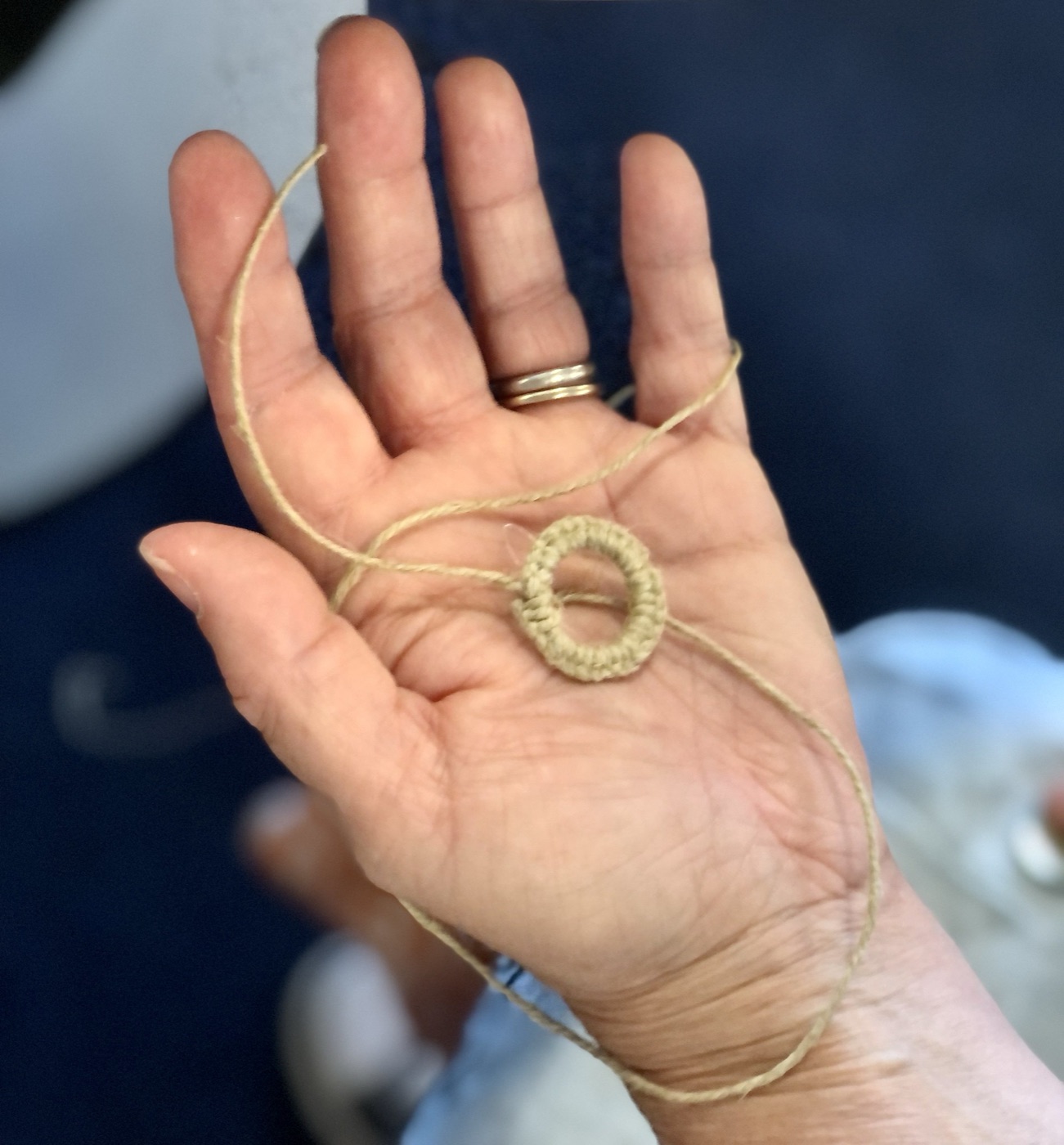Hands weaving during a festival workshop
